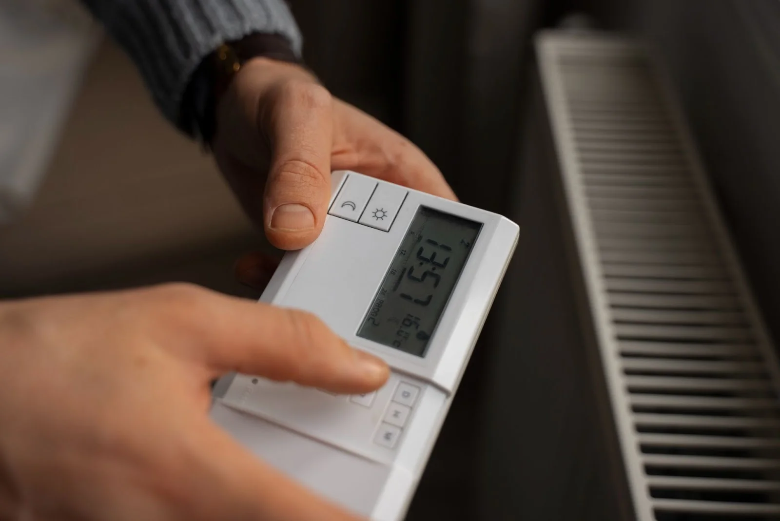 man-turning-off-thermostat-energy-crisis
